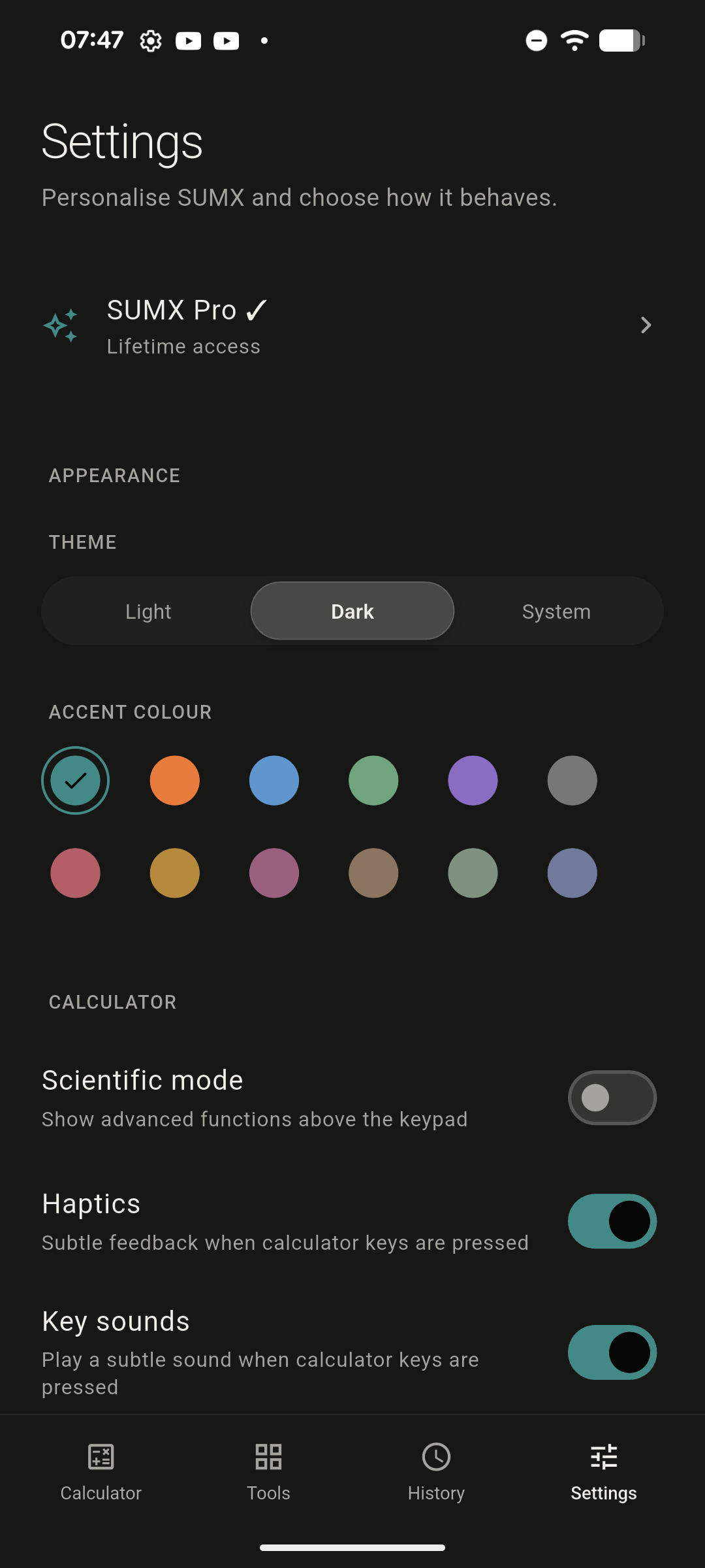 SUMX settings in dark theme. A Light, Dark and System theme switch sits above a grid of twelve accent colours with teal selected, followed by Scientific mode, Haptics and Key sounds toggles.